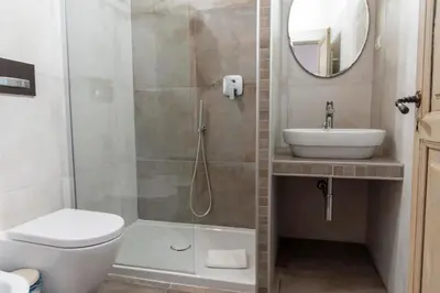 a bathroom with a shower and a toilet and a sink at Monti Bespoke in Rome