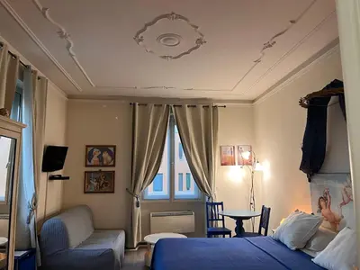 a bedroom with a bed and a chair and a window at B&B DolceVirginia in Rome