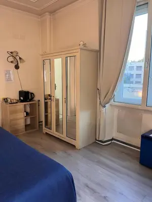 a bedroom with a bed and a cabinet and a window at B&B DolceVirginia in Rome
