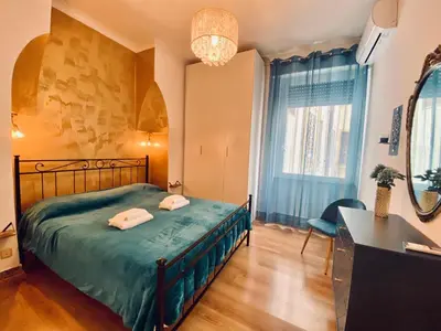 a bedroom with a bed and a desk and a mirror at GuestART Monti Apartment in Rome