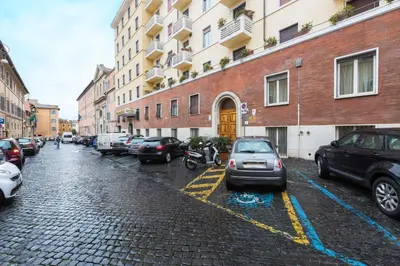 a cobblestone street with parked cars and buildings at GuestART Monti Apartment in Rome