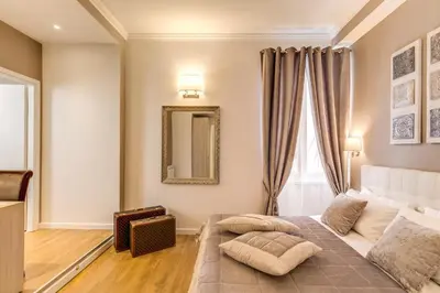 a bedroom with a bed and a mirror at The Bridge Suites in Rome