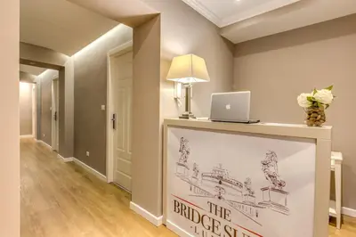a hallway with a table with a laptop on it at The Bridge Suites in Rome