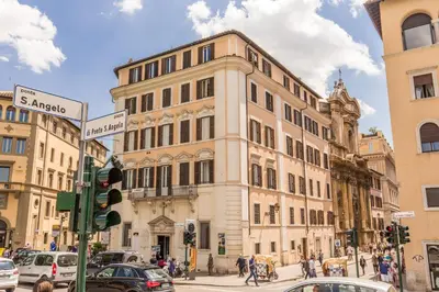 a large building on a busy city street with cars at The Bridge Suites in Rome