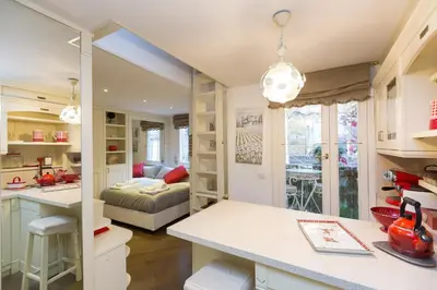 a kitchen and living room with a couch in the background at Pantheon Romantic Loft in Rome