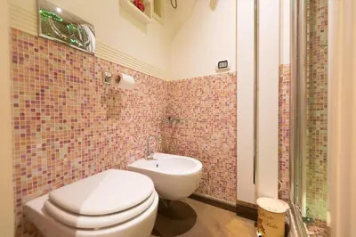 a bathroom with a toilet and a sink at Pantheon Romantic Loft in Rome