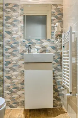 a bathroom with a white sink and a toilet at St. Peter Vatican Apartment in Rome
