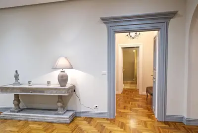 a hallway with a table and a lamp on a wall at Carducci Luxury Apartment in Rome