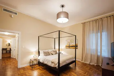 a bedroom with a canopy bed in a room at Carducci Luxury Apartment in Rome