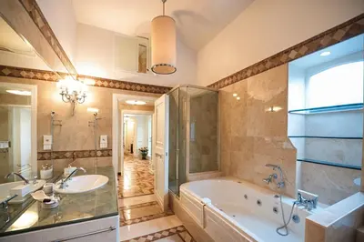a large bathroom with a tub and a sink at Carducci Luxury Apartment in Rome