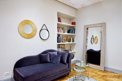 a living room with a couch and a mirror at Carducci Luxury Apartment in Rome