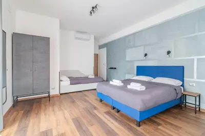 a bedroom with a large blue bed in a room at Luciano Licia Guest House in Rome