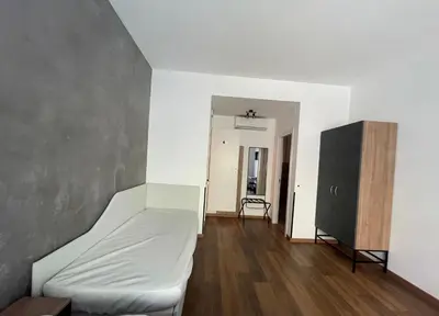 an empty room with a bed and a black cabinet at Luciano Licia Guest House in Rome