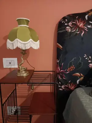a lamp sitting on a table next to a bed at Colosseum B in Rome