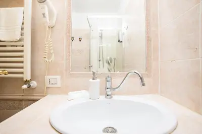 a bathroom with a sink and a shower at Colosseum B in Rome