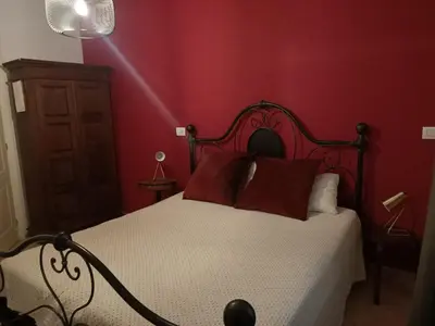 a red bedroom with a bed with red walls at Colosseum B in Rome