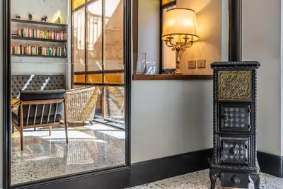 a mirror in a room with a chair and a table at Albergo Etico Roma in Rome