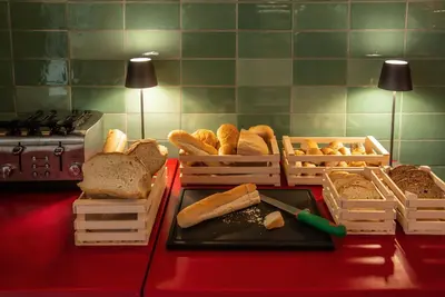 a table with crates of bread and baskets of bread at Albergo Etico Roma in Rome