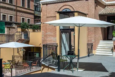 a table and an umbrella in front of a building at Albergo Etico Roma in Rome