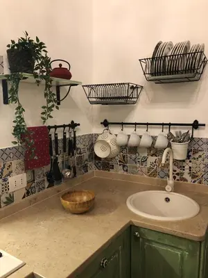 a kitchen with a sink and a counter with pots and pans at 