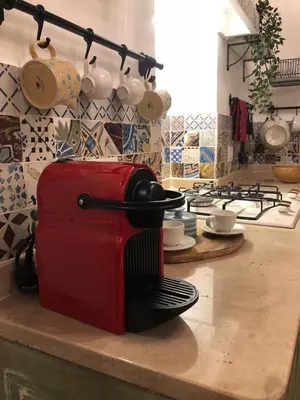 a red toaster sitting on a counter in a kitchen at 