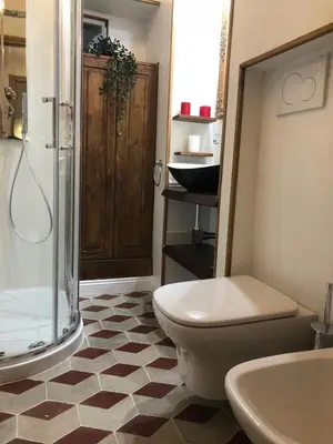 a bathroom with a shower and a toilet and a sink at 