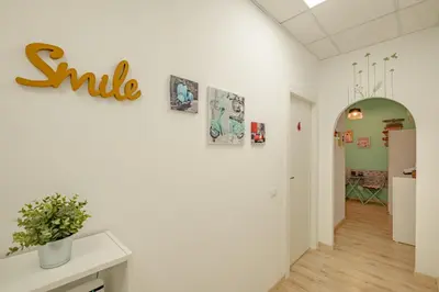 a hallway with a smile sign on a wall at Damiani & Sister Guesthouse in Rome