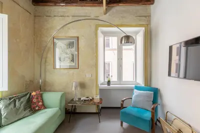 a living room with a couch and a chair at iFlat Vatican High-End Apartment in Rome