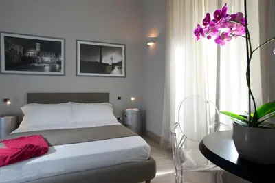 a bedroom with a bed and a table with a plant at B&B Best Vatican in Rome