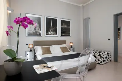 a bedroom with a bed and a table with a flower at B&B Best Vatican in Rome
