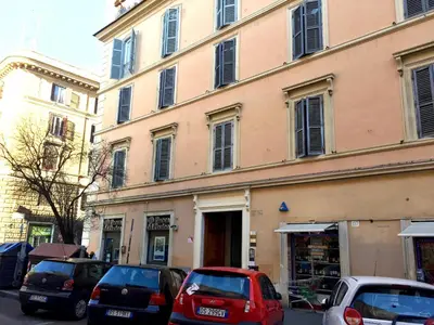 a building with cars parked in front of it at B&B Best Vatican in Rome