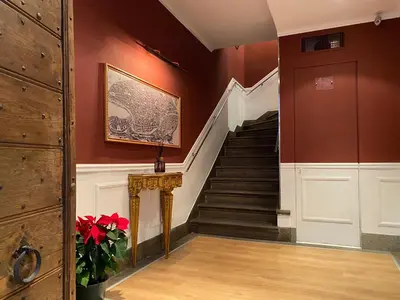 a hallway with a staircase in a house at HiSuiteROME - ApartHotel in Rome
