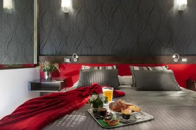 a hotel room with a tray of food on a bed at HiSuiteROME - ApartHotel in Rome