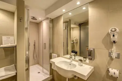 a bathroom with a sink and a shower at HiSuiteROME - ApartHotel in Rome