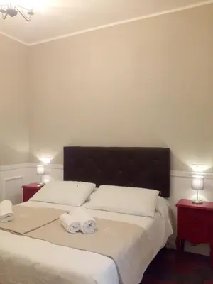 a bedroom with a bed with two towels on it at Trastevere Glasshouse in Rome