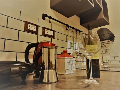 a counter with a blender and a glass of wine at Domus Angelica in Rome