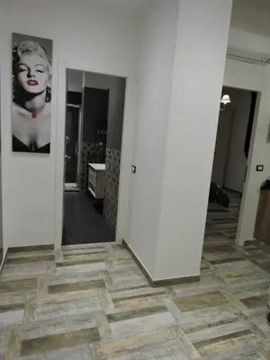 a hallway with a mirror and a painting on the wall at Domus Angelica in Rome