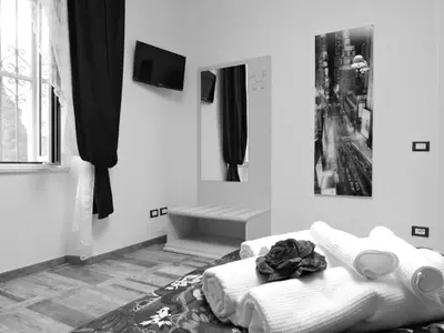 a living room with a white couch and a tv at Domus Angelica in Rome