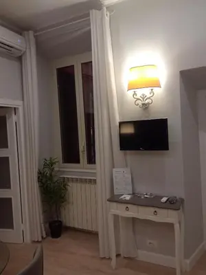 a room with a table and a lamp and a window at Fontana Di Trevi - Central Apartment in Rome in Rome