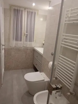 a small bathroom with a toilet and a sink at Fontana Di Trevi - Central Apartment in Rome in Rome
