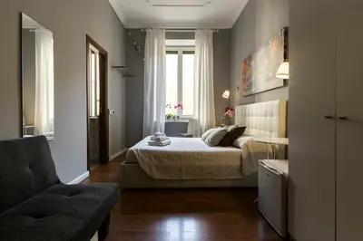 a bedroom with a bed and a chair at Dulcis In Fundo b&b in Rome