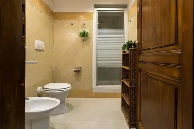 a bathroom with a toilet and a sink and a window at Dulcis In Fundo b&b in Rome