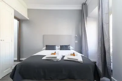 a bedroom with a large bed with two pillows on it at White Caesar Guesthouse in Rome