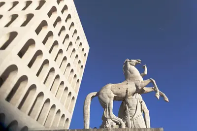 a statue in front of a tall building at Casa Veniero in Rome