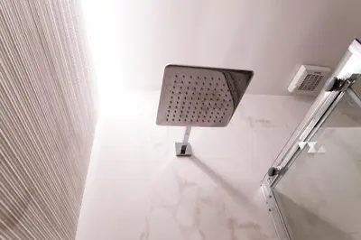 a white bathroom with a light on the wall at Casa Veniero in Rome