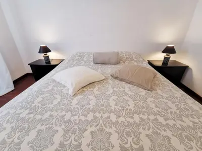 a bedroom with a large bed with two lamps at Borgo Pio San Pietro Apartment in Rome