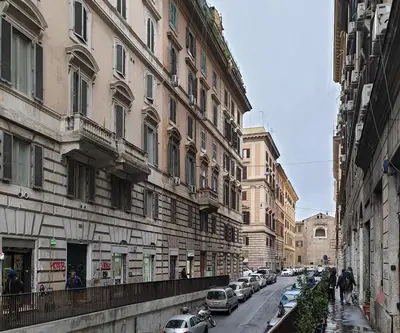 a city street with cars parked next to buildings at Pimpinella in Rome
