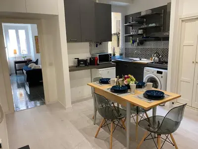 a kitchen with a table and chairs in a kitchen at Pimpinella in Rome