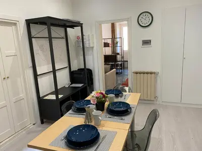 a dining room with a table with blue plates on it at Pimpinella in Rome
