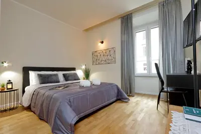 a bedroom with a large bed and a piano at Termini Terrace in Rome